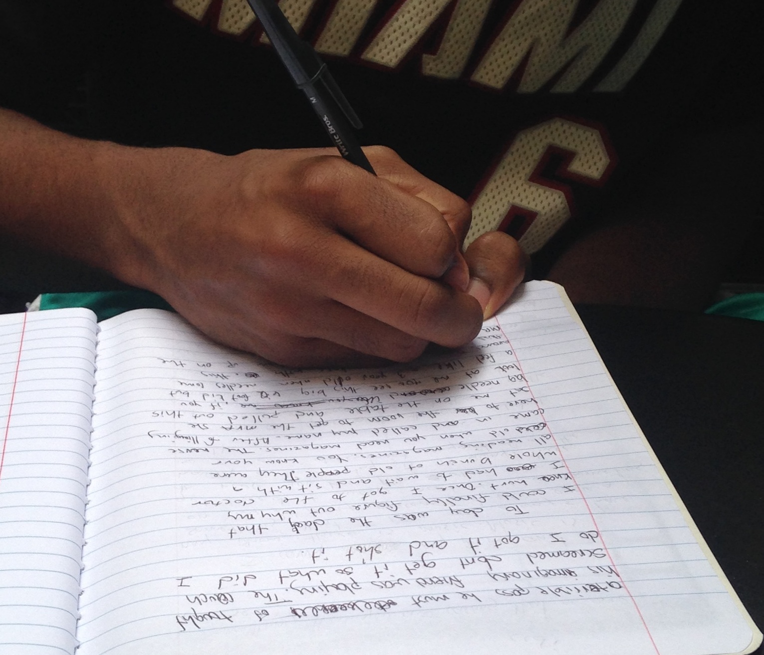 Hand free-writing essay in notebook